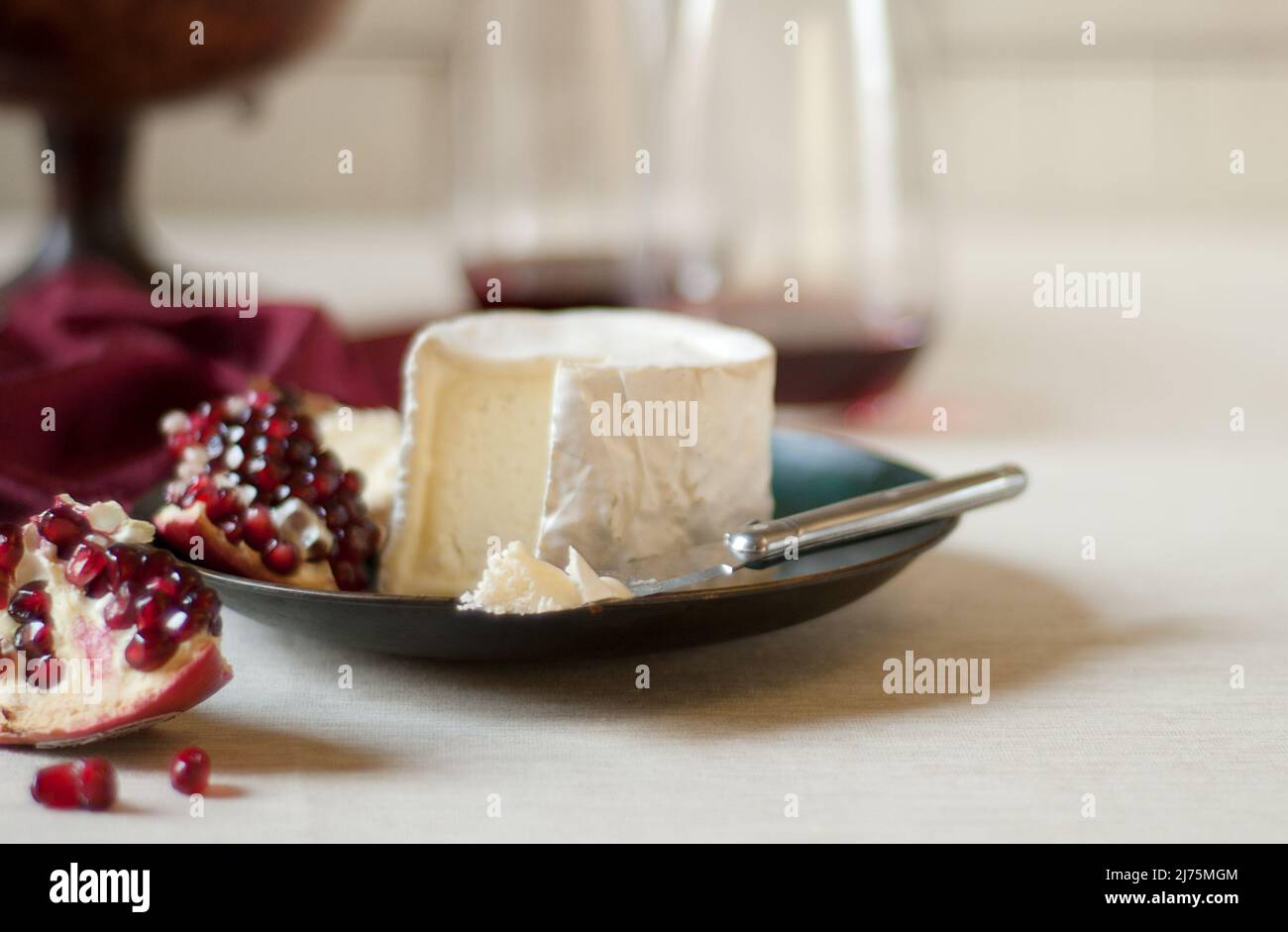 Brie with Pomegranate; Some Brie on a Knife Stock Photo Alamy