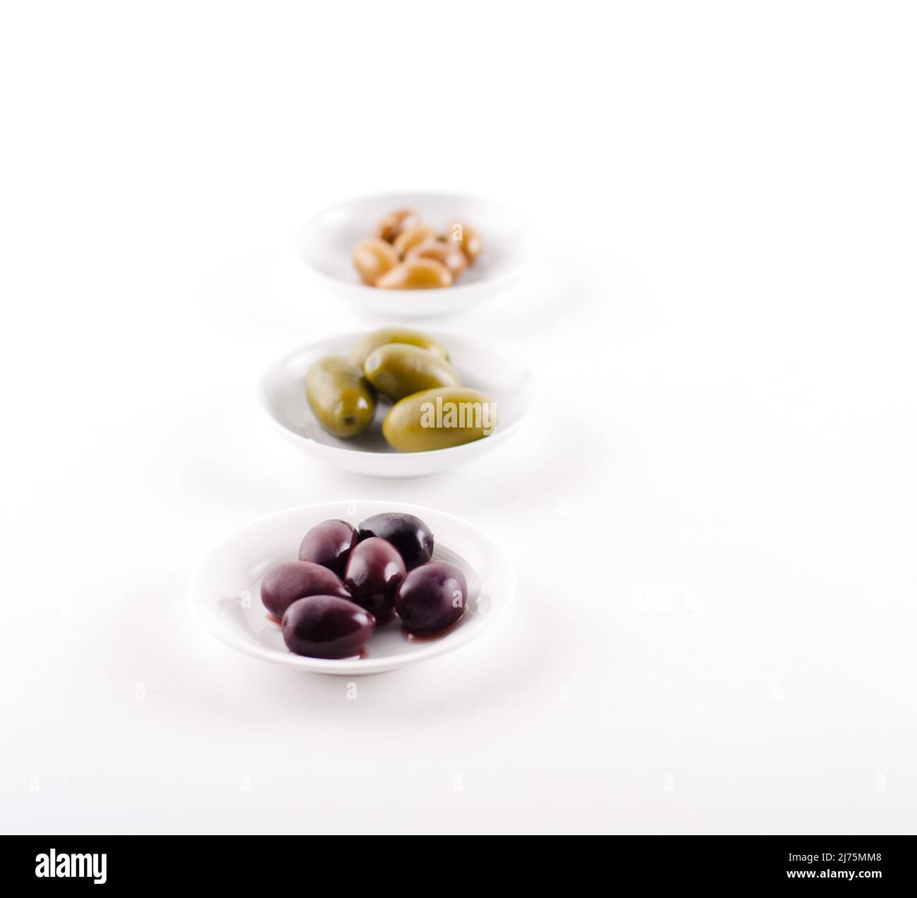 Three Types of Olives in Small White Dishes Stock Photo Alamy