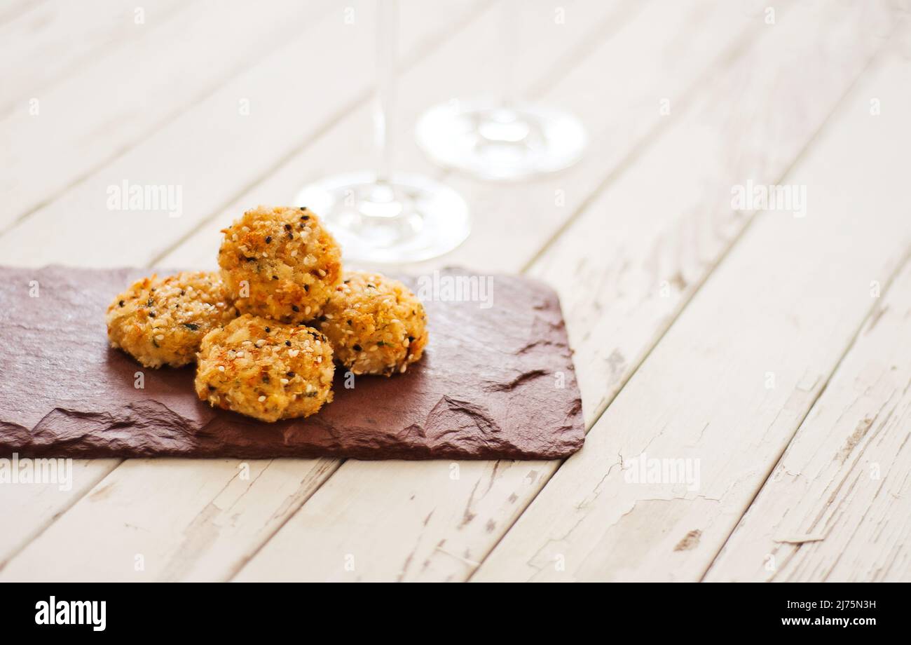 Small Crab Cake Appetizers on Slate on a Picnic Table Stock Photo