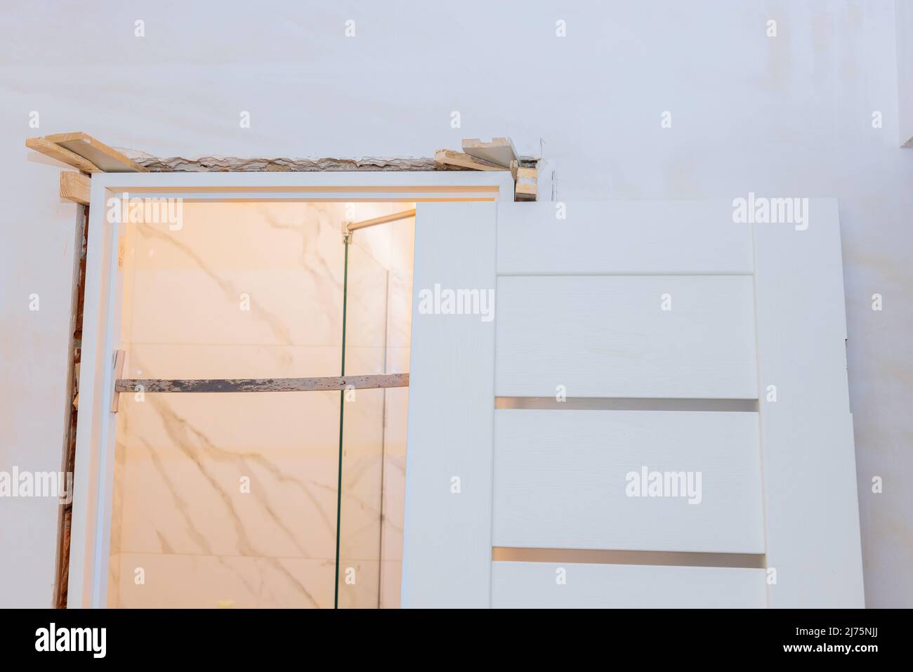 Installing door unit the door frame using a mounting foam. Stock Photo