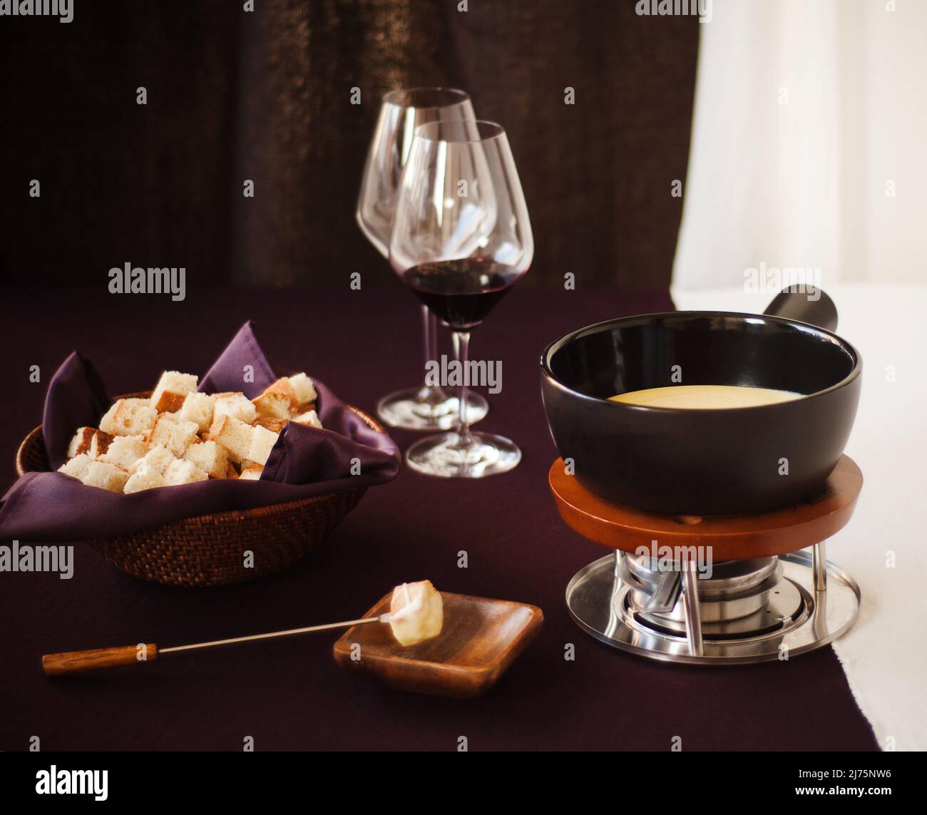 Cheese Fondue with Bread and Red Wine Stock Photo