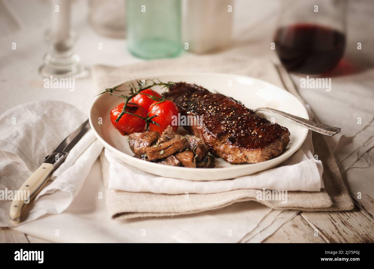 Steak with roasted mushrooms and tomatoes Stock Photo