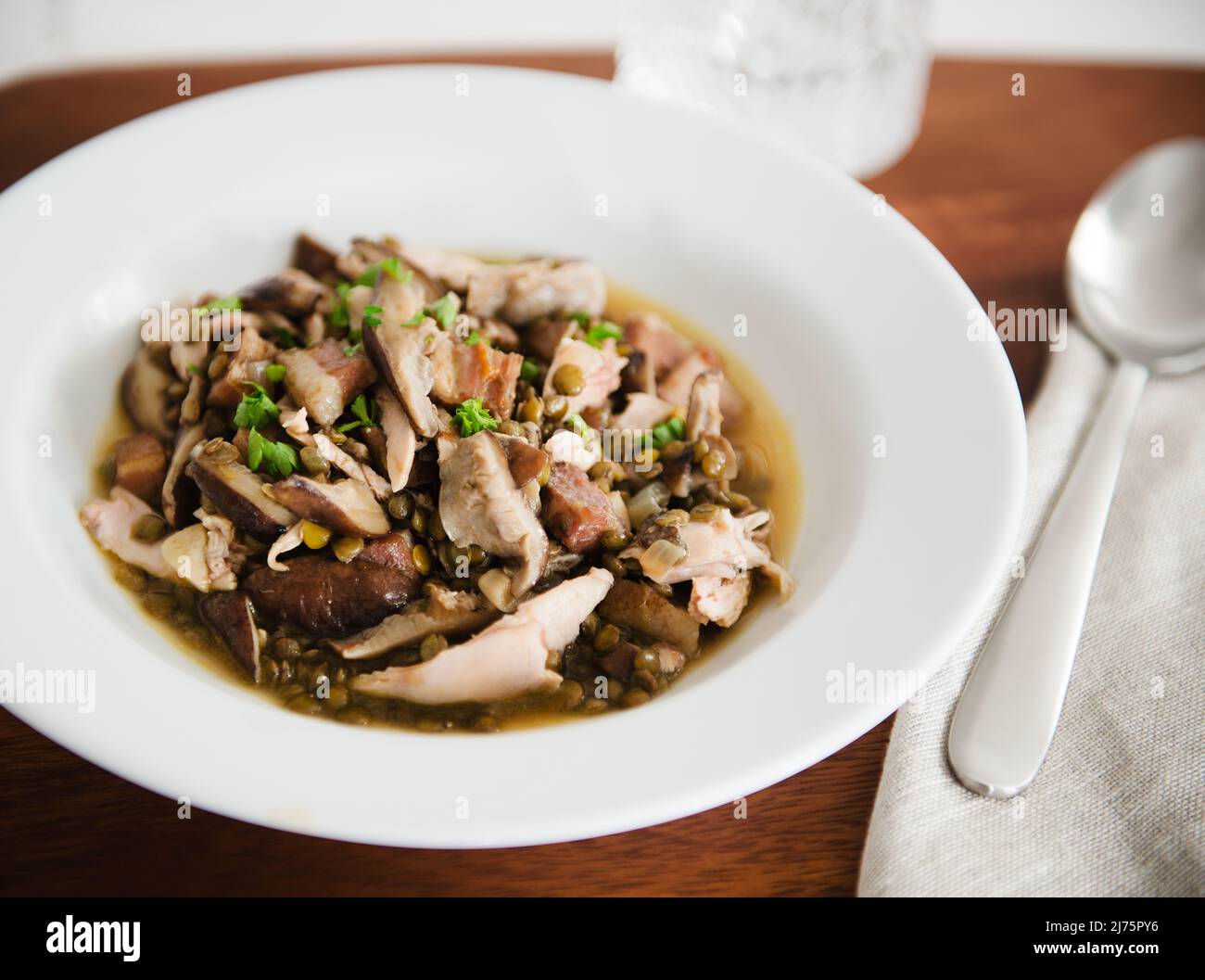 A Bowl of Chicken, Lentil and Mushroom Soup Stock Photo
