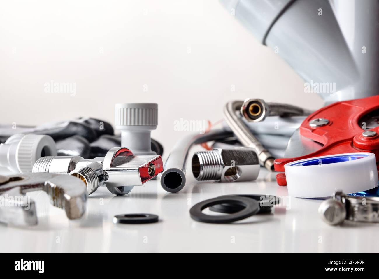 Sample of plumbing materials and tools on white. Front view. Horizontal composition. Stock Photo