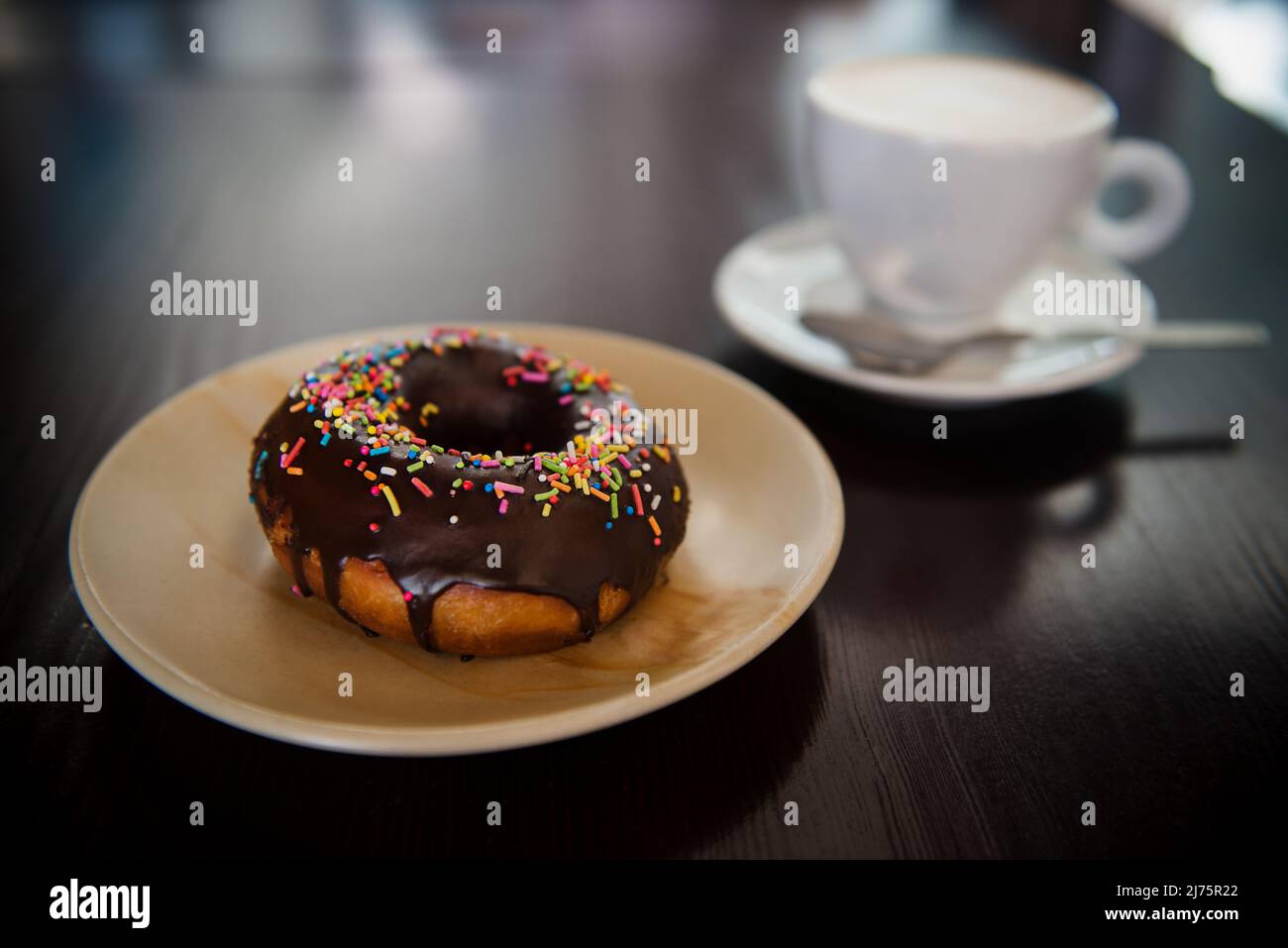 Chocolate donut with sprinkles and coffee Stock Photo