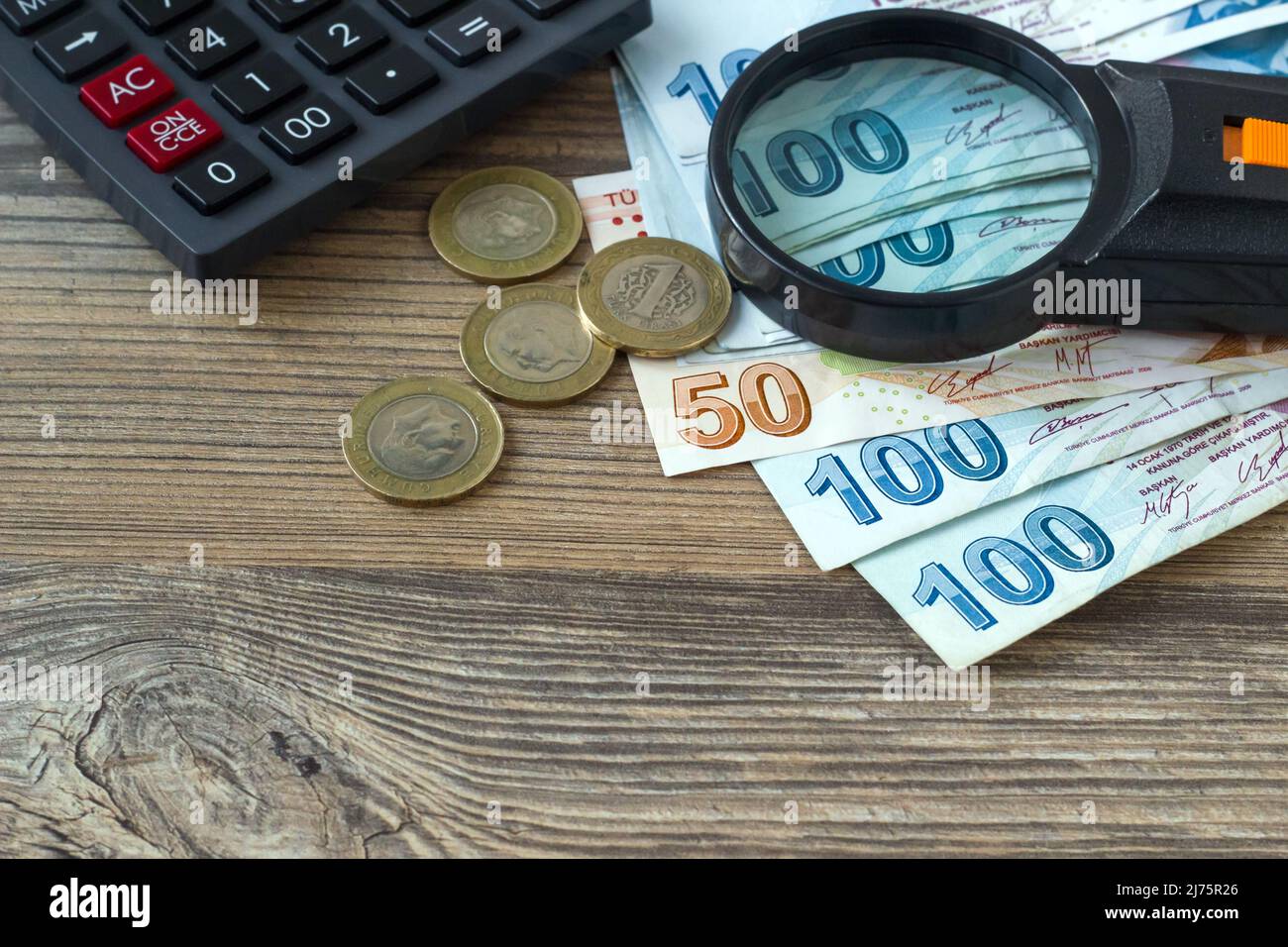 Turkish lira banknotes, coins and calculator paper currency of Turkey on  white background. For tax, raise and minimum wage news Stock Photo - Alamy