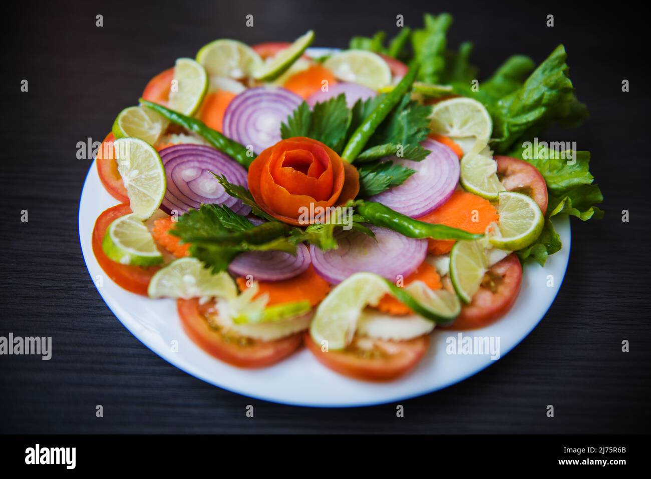 Mixed vegetable salad with tomatoes, red onions and limes Stock Photo