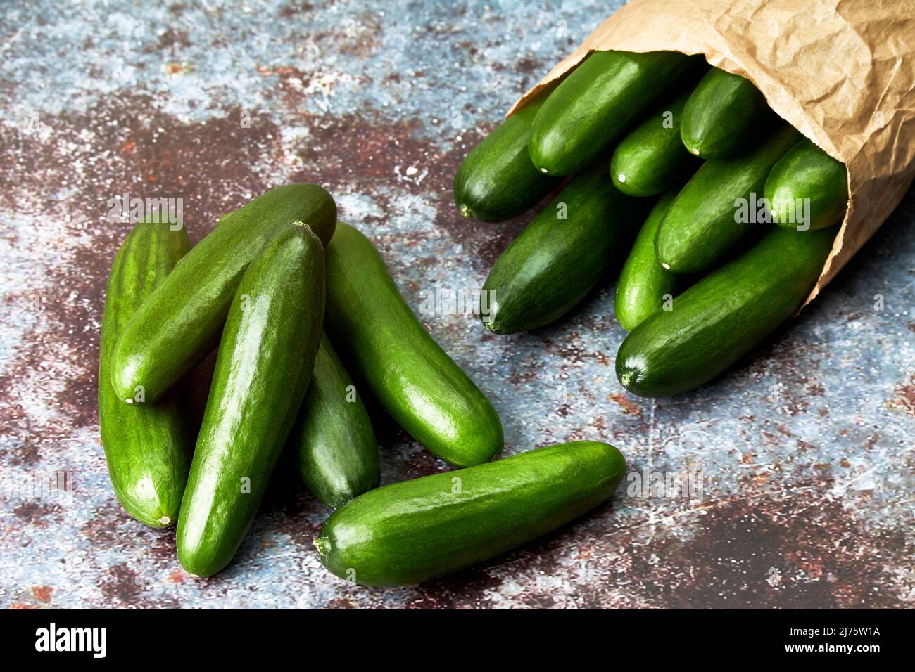 Healthy organic baby cucumbers in a paper bag. Healthy snack food. Vegan and vegetarian food Stock Photo