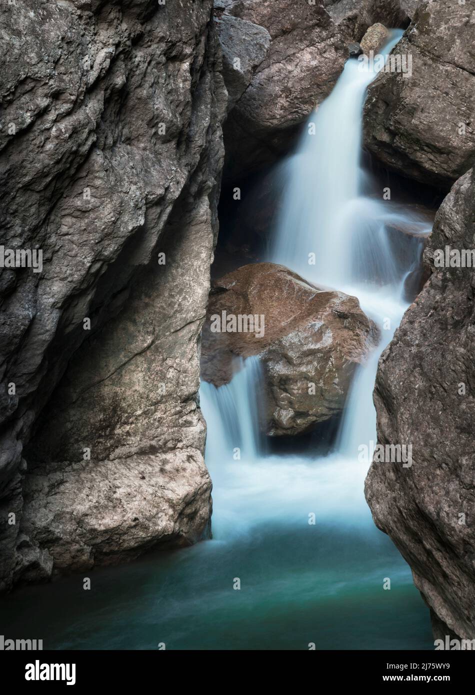 Small waterfall between rocks. Long exposure. Allgäu Alps, Germany Stock Photo