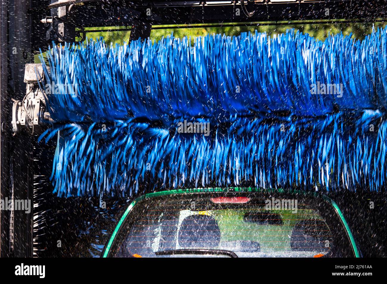 blue rotating brushes and water drops in a machinery for automatic car