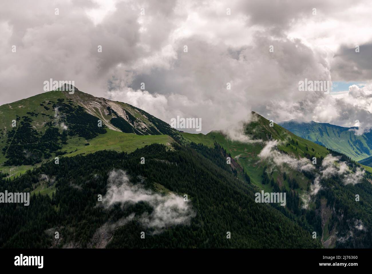 The Schafreuter, a popular mountain in the German-Austrian border area, in the Karwendel, in dense clouds and rainy weather. If you look closely, you will discover the hut in the center of the picture. Stock Photo