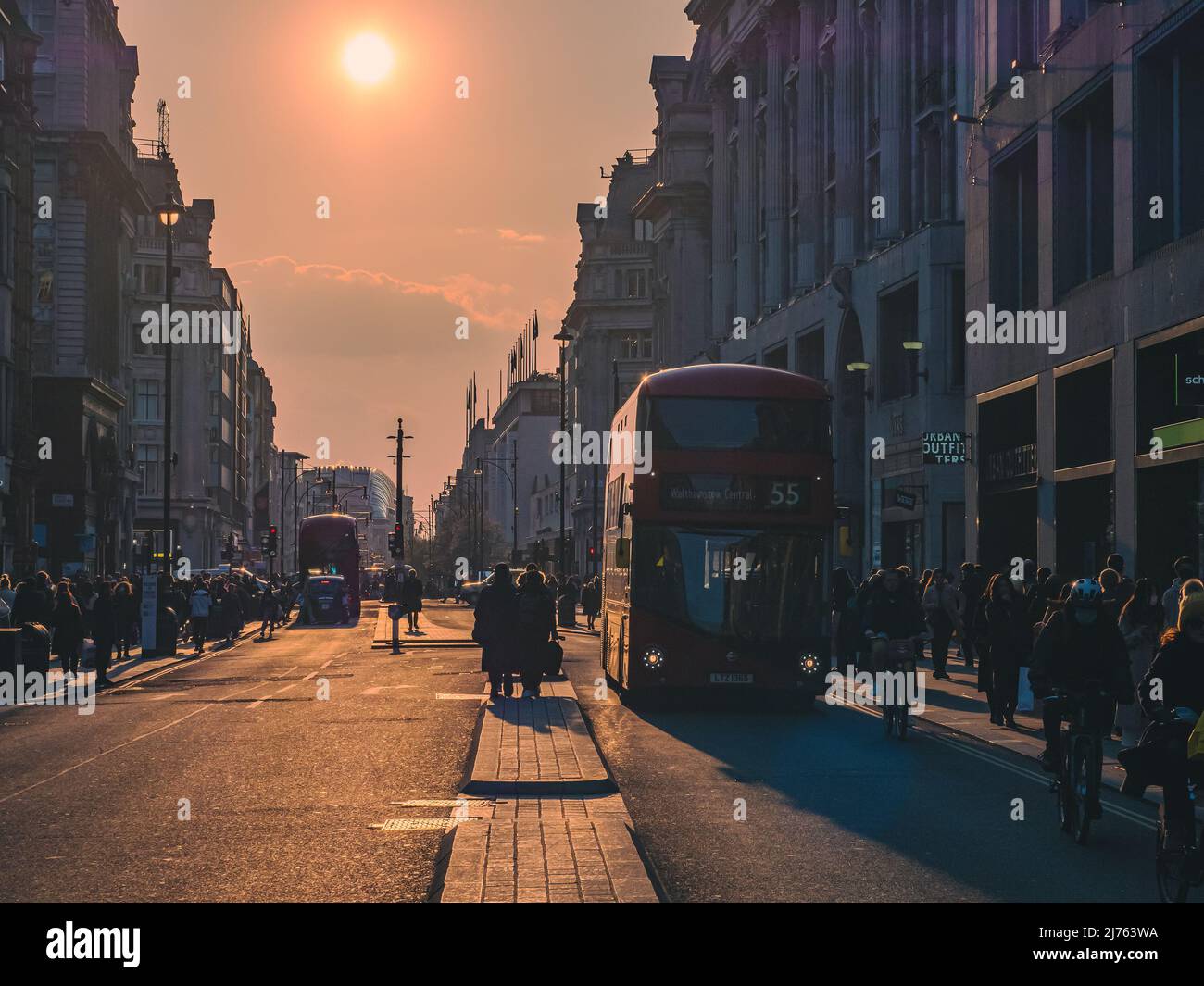 London, England - April 2, 2022: Double-decker bus on the famous Oxford Street in London at the sunset Stock Photo