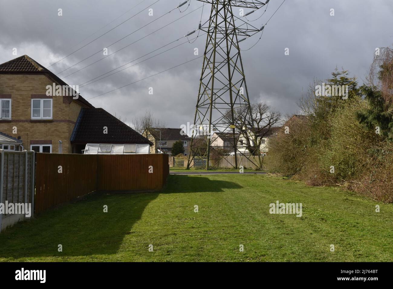Pylon within a housing estate, Frome, Somerset, UK Stock Photo