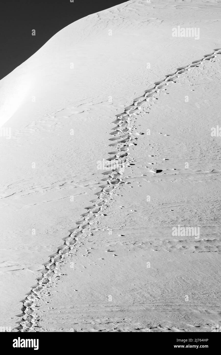 A single snowshoe track in the Karwendel on a mountain slope in the