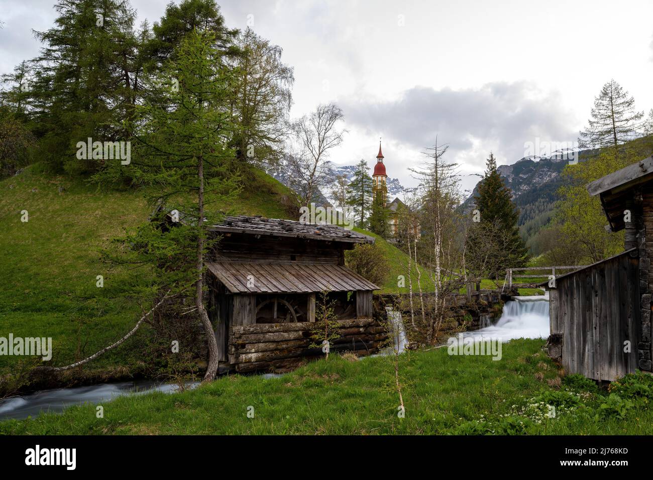 Two old mills on the stream near the church of St. Nicholas in Obernberg / Tyrol near the Brenner Pass. Stock Photo