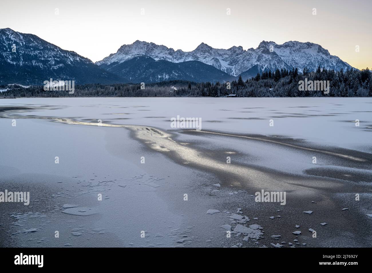 The frozen Barmsee near Krün in the Bavarian foothills of the Alps. In ...