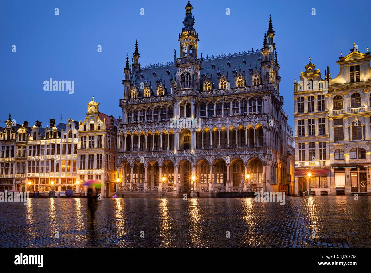 Belgium, Brussels, Grand Place, Market Square, UNESCO World Heritage Site, Broodhuis, Musée de la ville de Bruxelles, City Museum at blue hour with out of focus person in foreground Stock Photo
