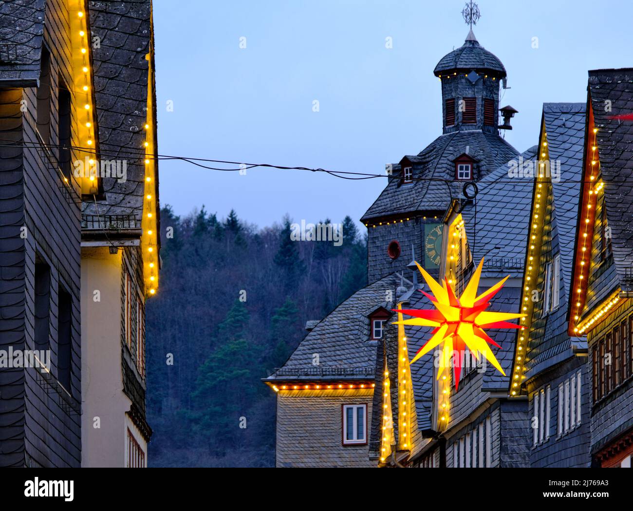Europe, Germany, Hesse, city of Herborn, historic old town, Christmas, Christmas lights, historic house gables in the main street, town hall, poinsettia Stock Photo