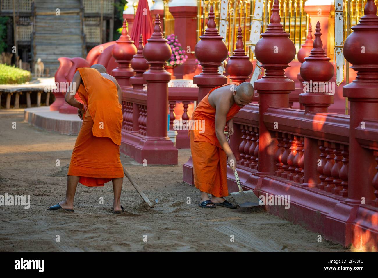 CHIANG MAY, THAILAND - DECEMBER 22, 2018: Young monks clean up the grounds of Wat Phantao Buddhist temple on a sunny morning Stock Photo