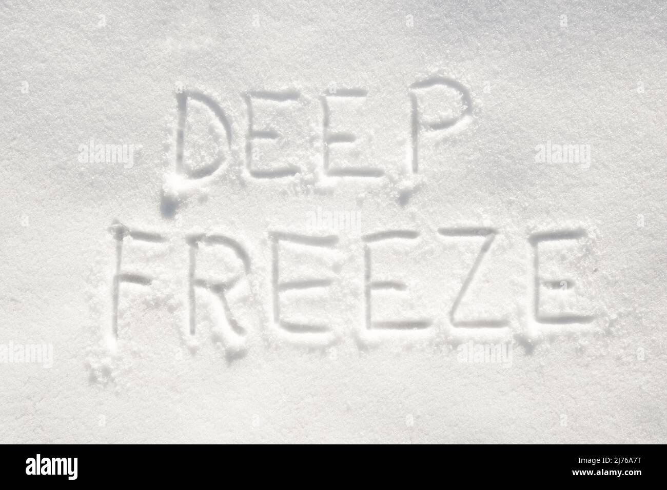 Text 'deep freeze' written in snow; concept of very cold weather arriving Stock Photo