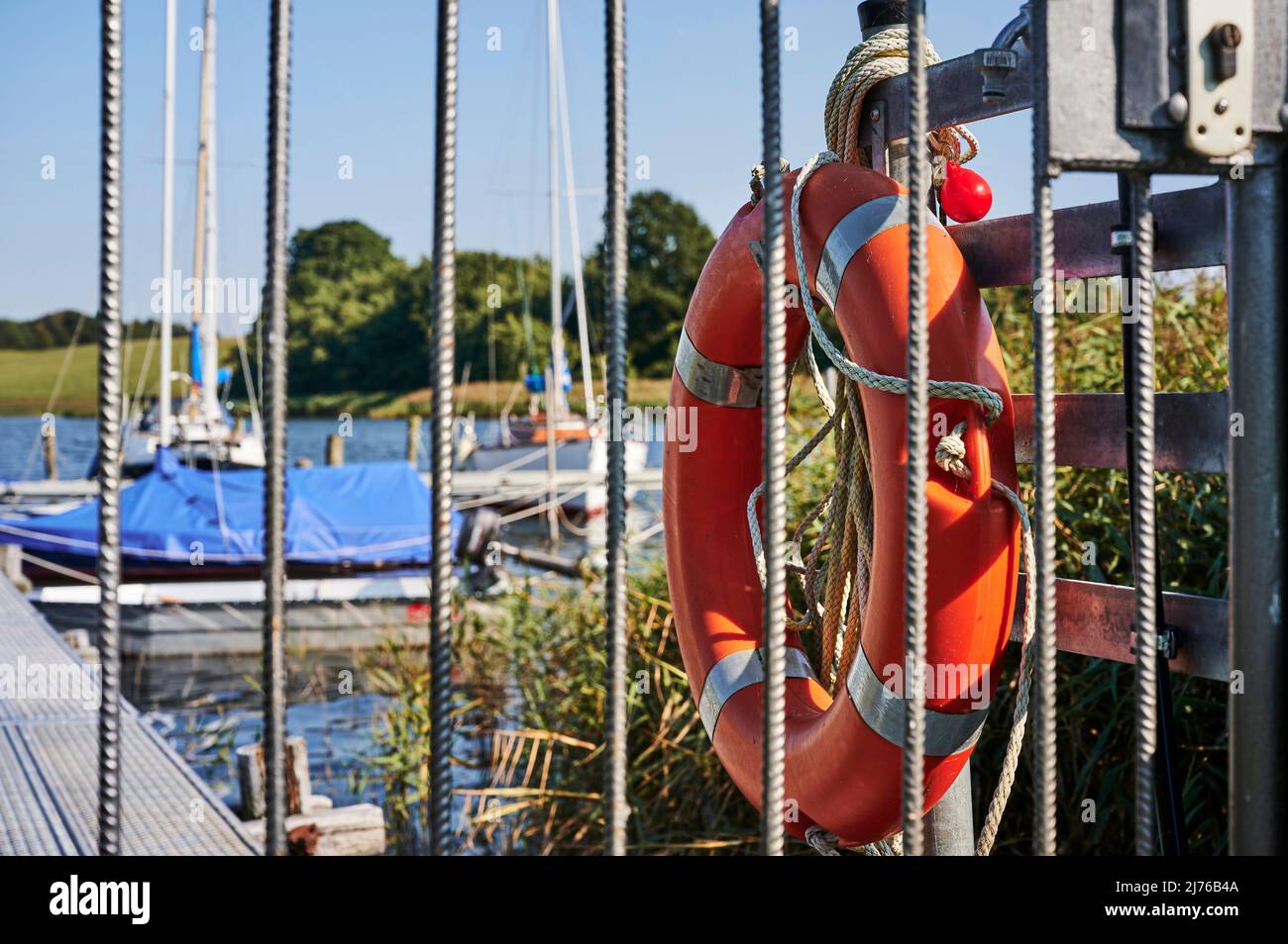 Water landscape of the Schlei, inlet in Schleswig-Holstein, jetty near Missunde, red life preserver Stock Photo