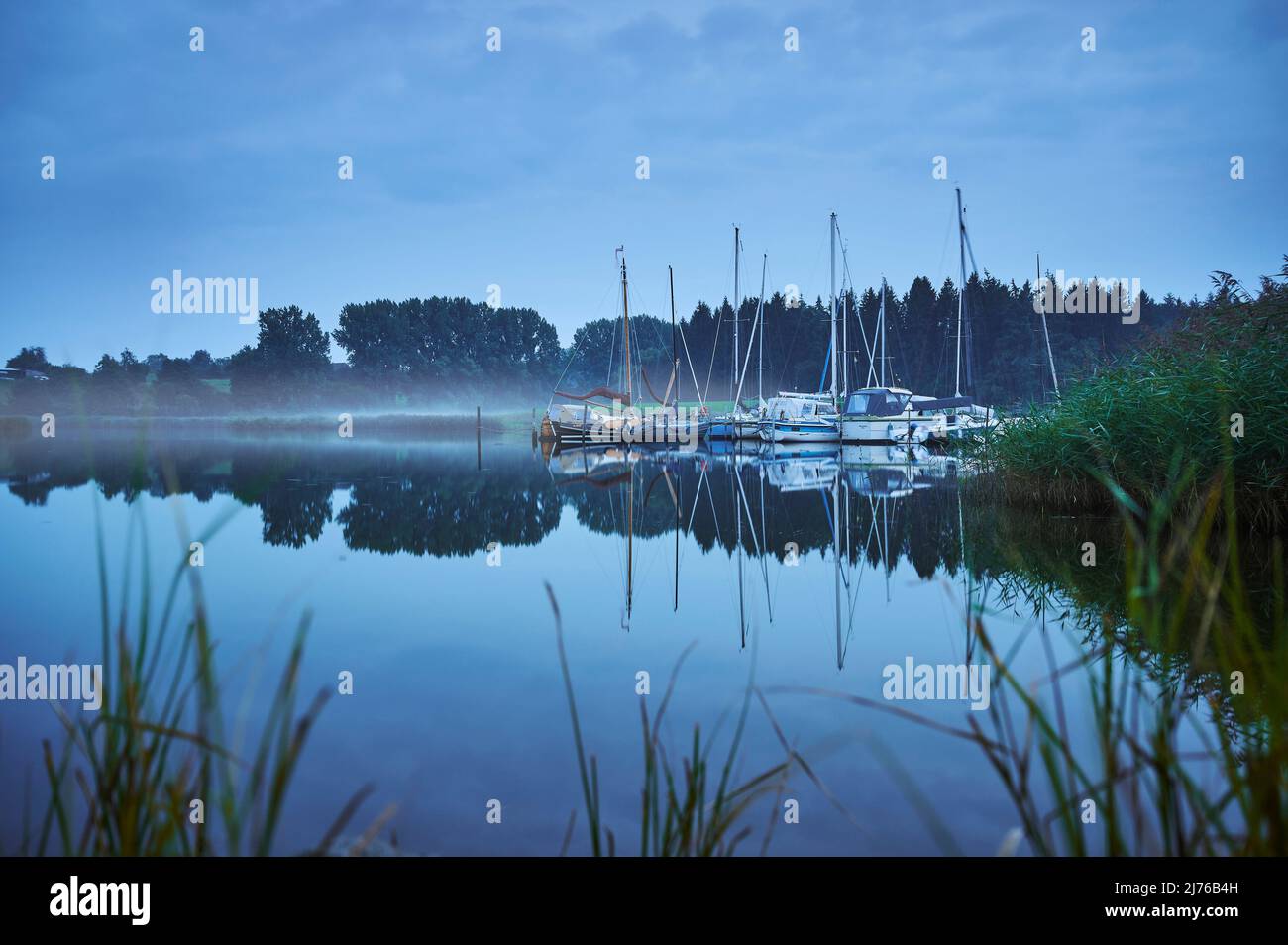 Water landscape of the Schlei, inlet in Schleswig-Holstein, Missunde, night shot at the jetty, rising fog Stock Photo