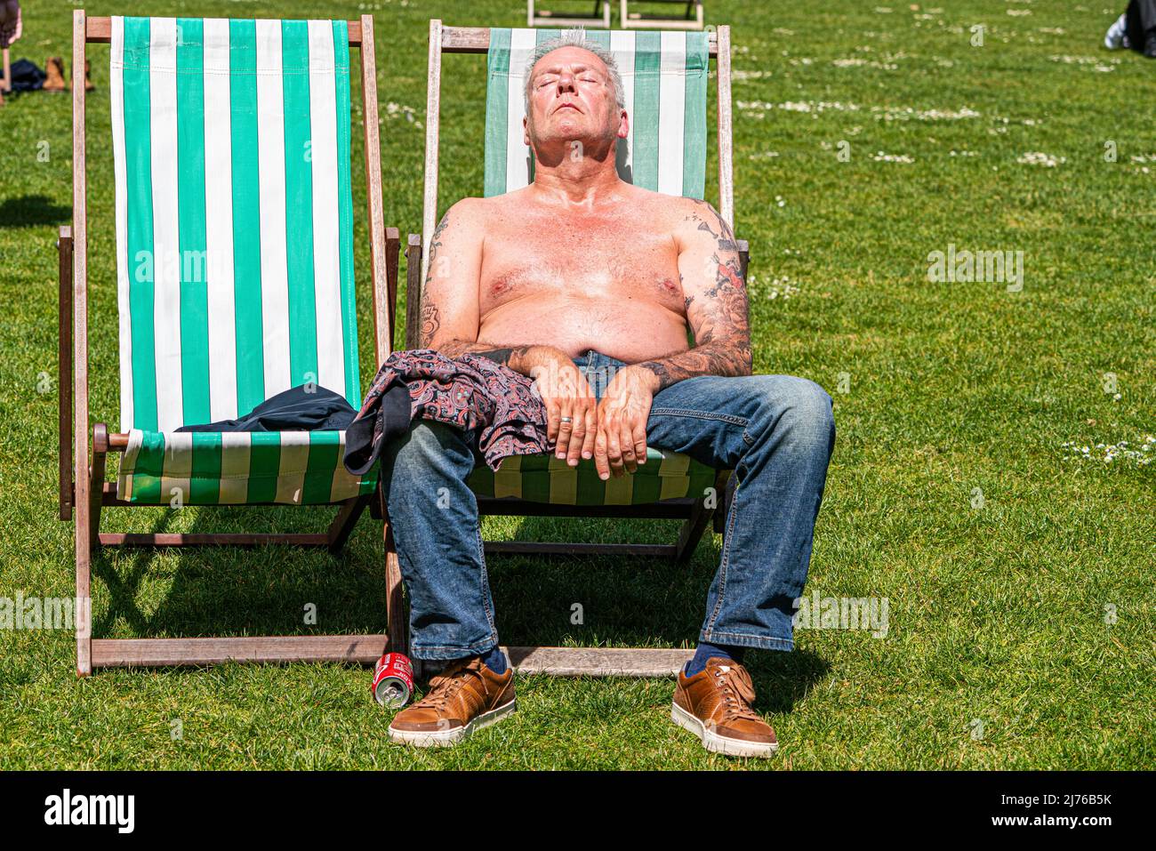 london-uk-6-may-2022-a-man-sunbathing-a-deckchair-in-saint-james-park