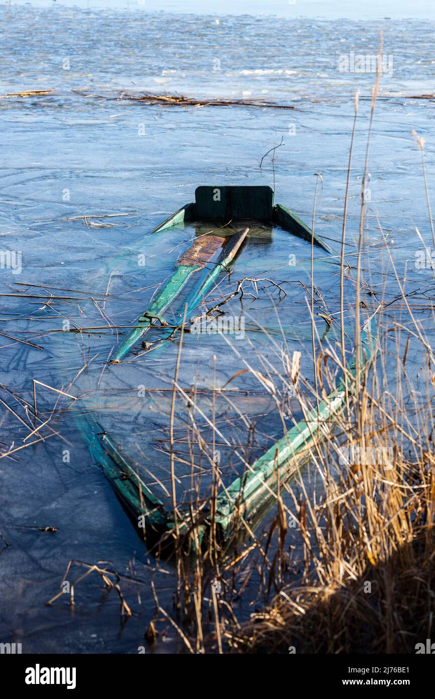 Europe, Poland, Podlaskie Voivodeship, Suwalskie Region, Lake Wigry, sunken boat on shore Stock Photo