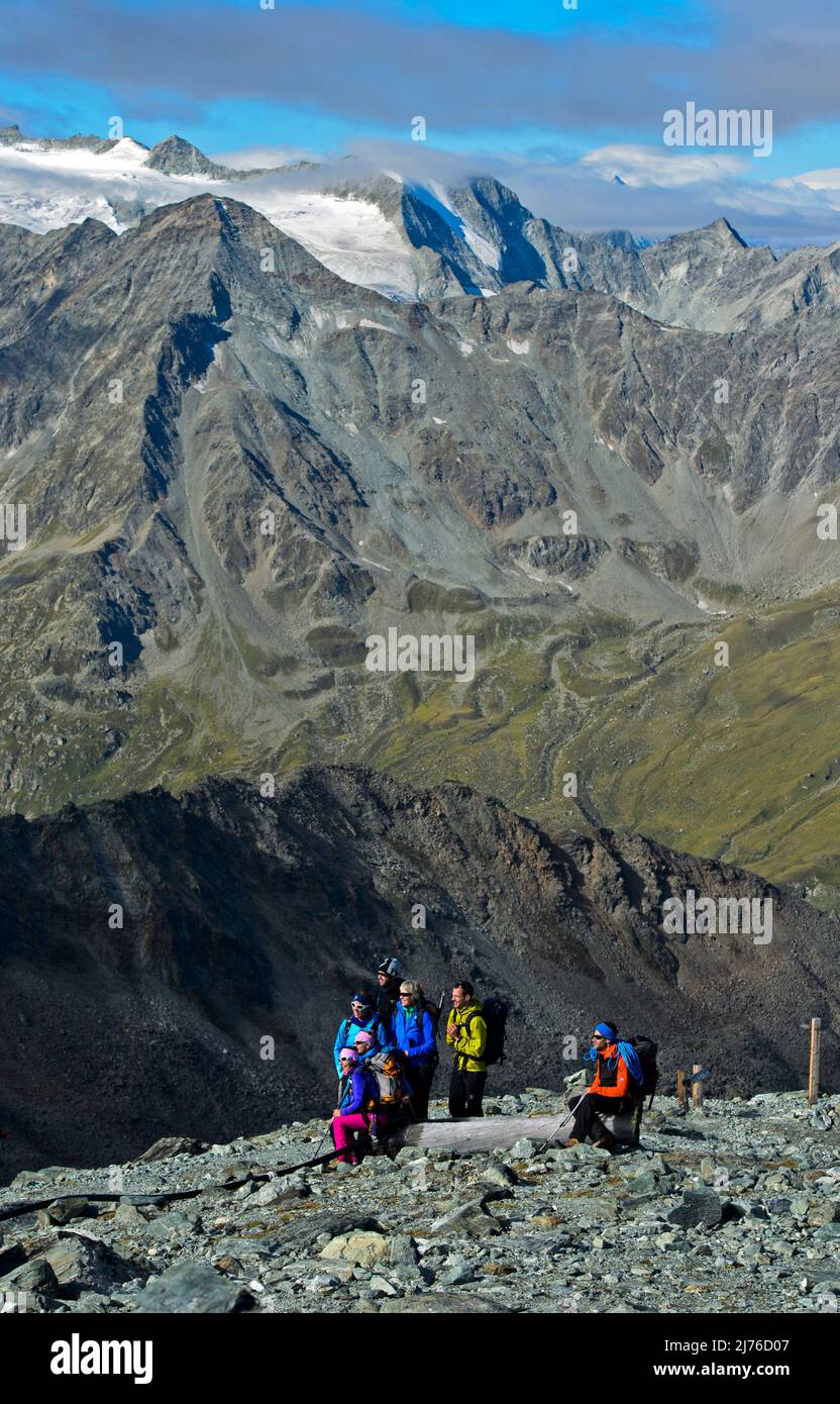 Hikers in the high mountains pose for a photo, near Zinal, Val d'Anniviers, Valais, Switzerland Stock Photo