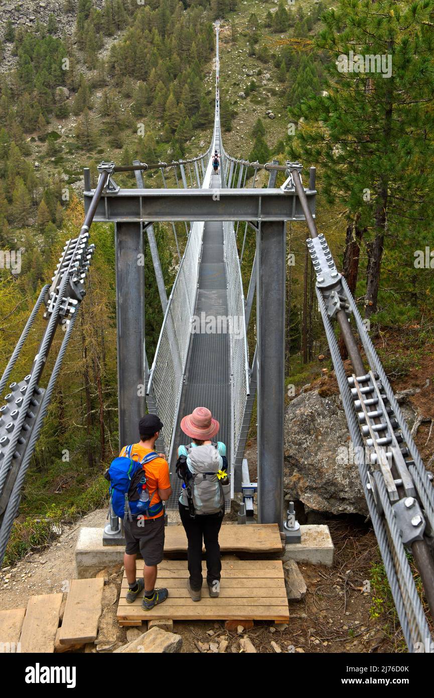 Uphill, hiker climbing on Charles Kuonen suspension bridge, Randa