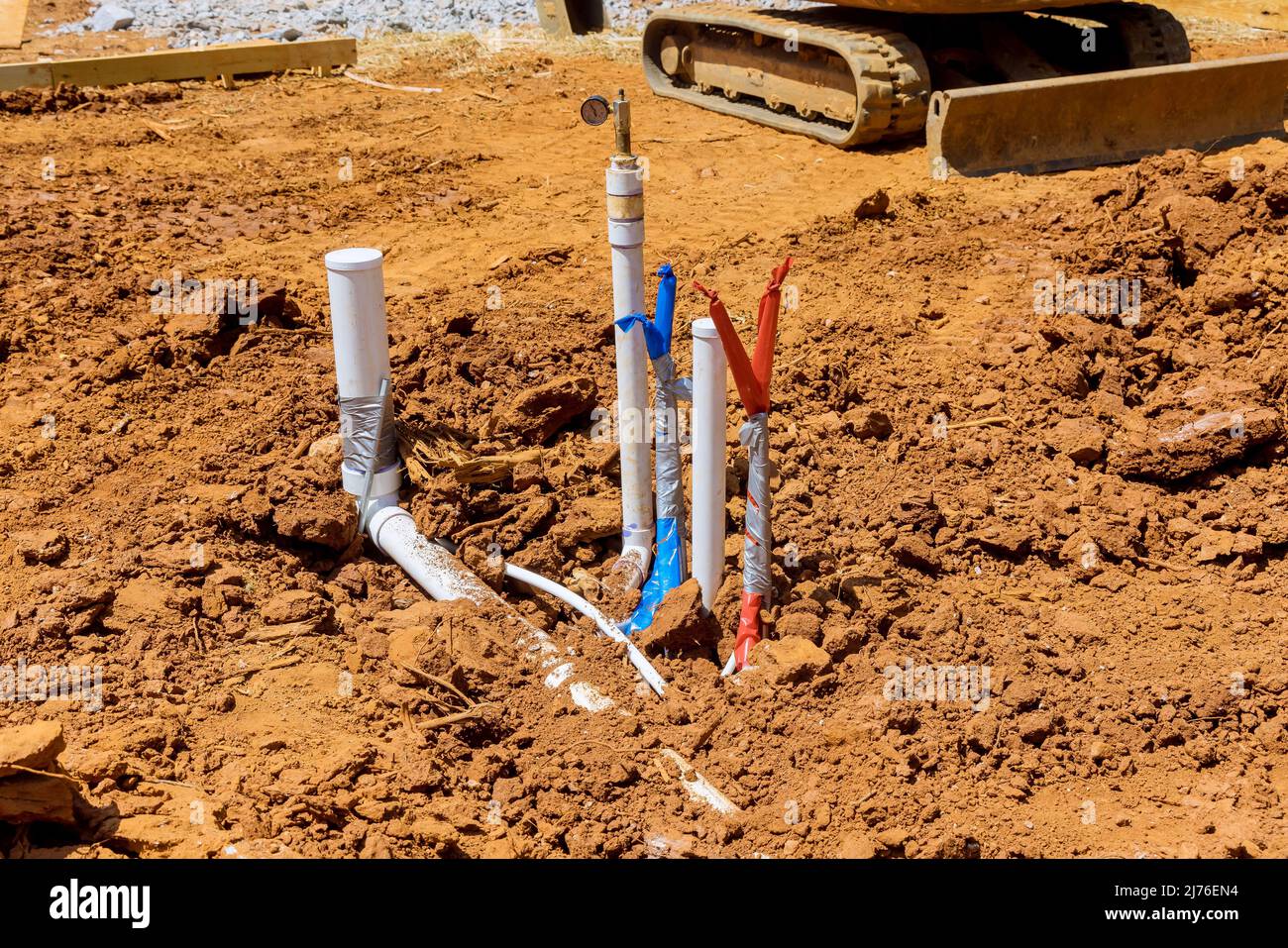 New residential home with laying sewer pipes and water pipe in the