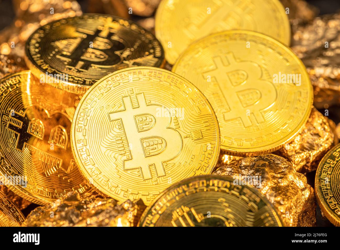 Bitcoins and pieces of gold closeup. Bitcoin against gold, what is the more  attractive asset Stock Photo - Alamy