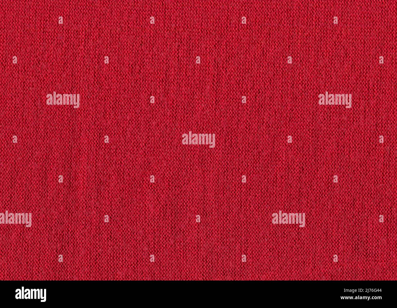 Textile red colored material with wicker pattern. Crimson colored knitting wool texture full frame. Stock Photo