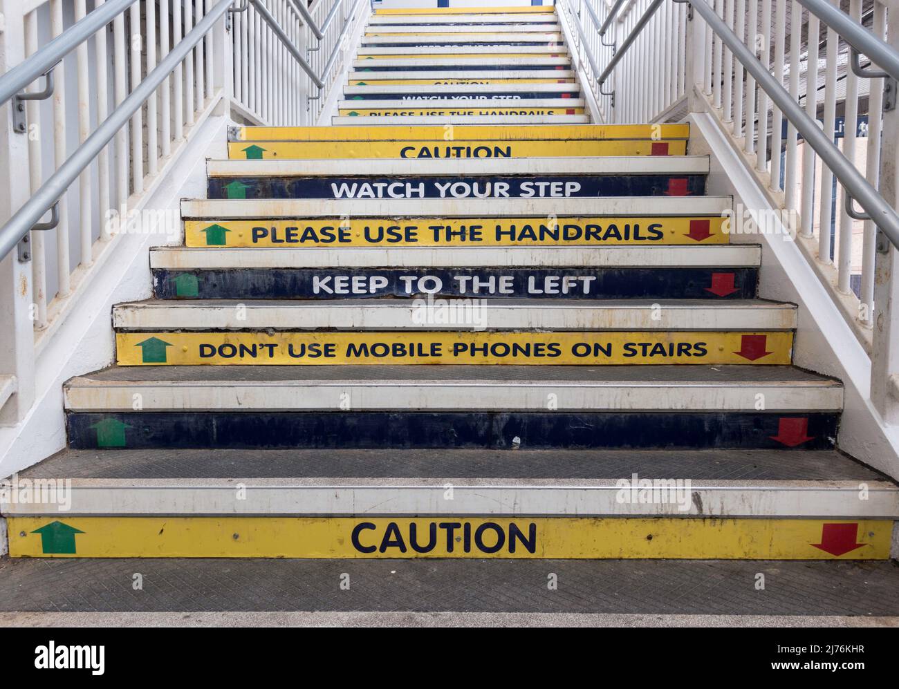 Safety warnings on the steps of the footbridge of Harrogate railway station, Yorkshire, England, UK Stock Photo