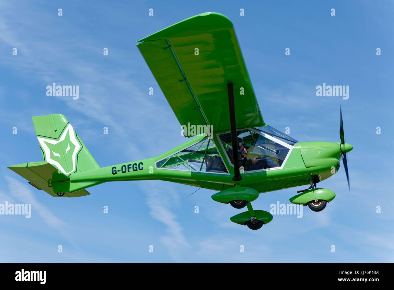 Immaculate Green Aeoprakt A22 Foxbat Home Built airplane G-OFGC takes off from Popham airfield in Hampshire England at the annual microlight aircraft Stock Photo