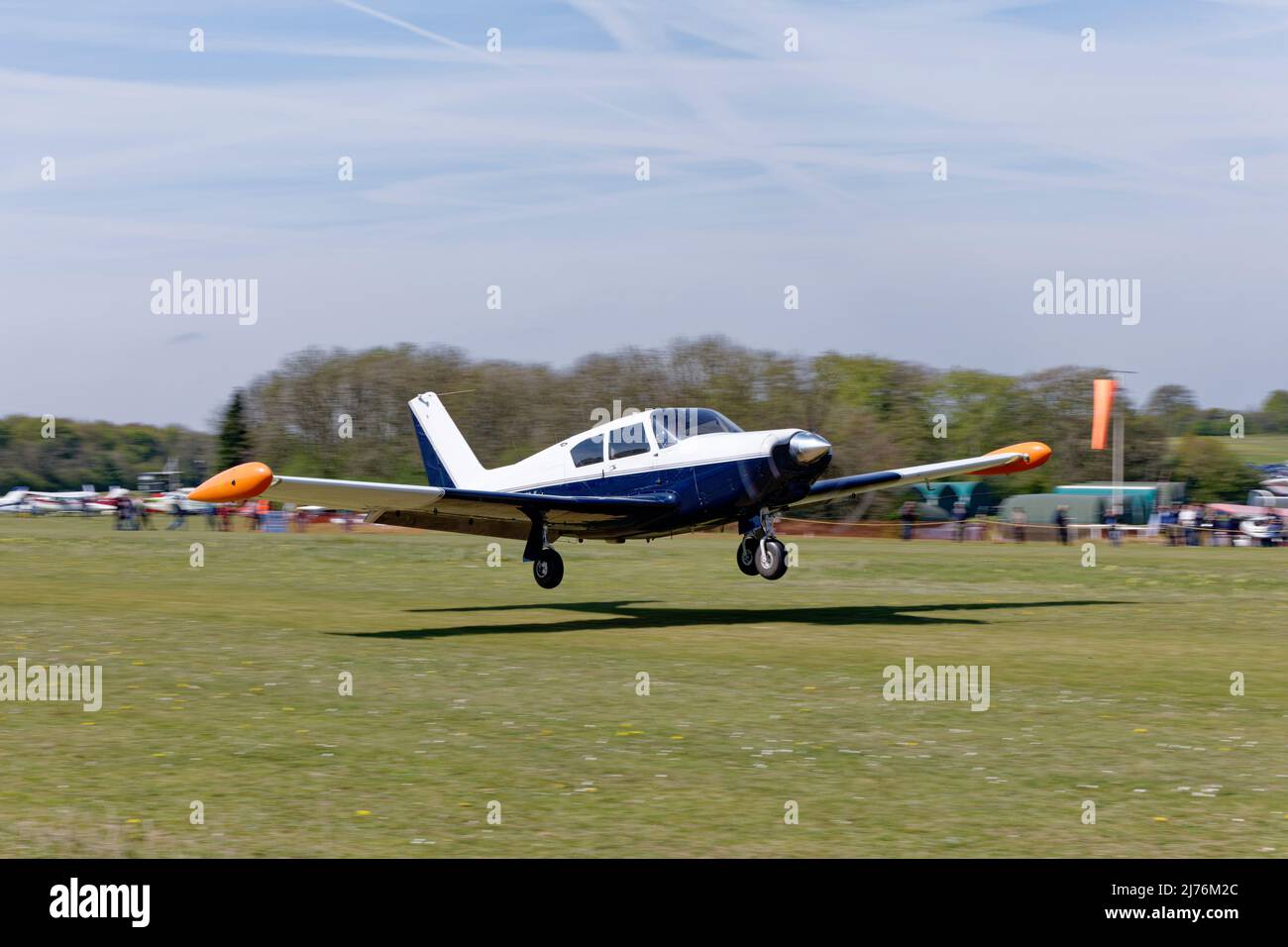 American registered Piper PA24 Comanche light airplane N84VK arrives Popham airfield in Hampshire England to attend the annual microlight aircraft fly Stock Photo