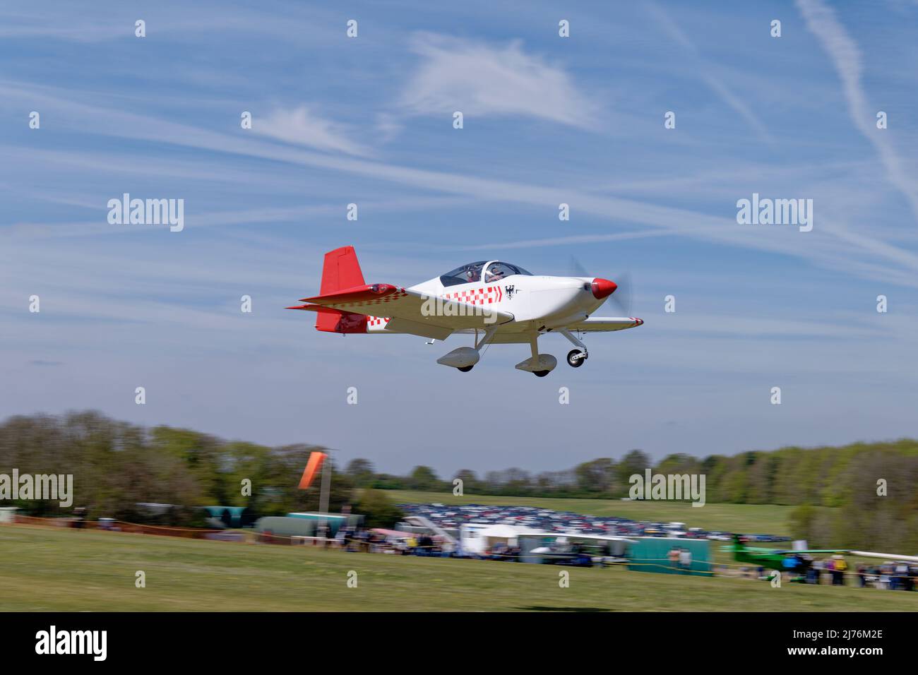 Smart Red & White Vans RV-7 airplane G-DPRV arrives at Popham airfield in Hampshire England to attend the annual microlight aircraft fly-in meeting Stock Photo