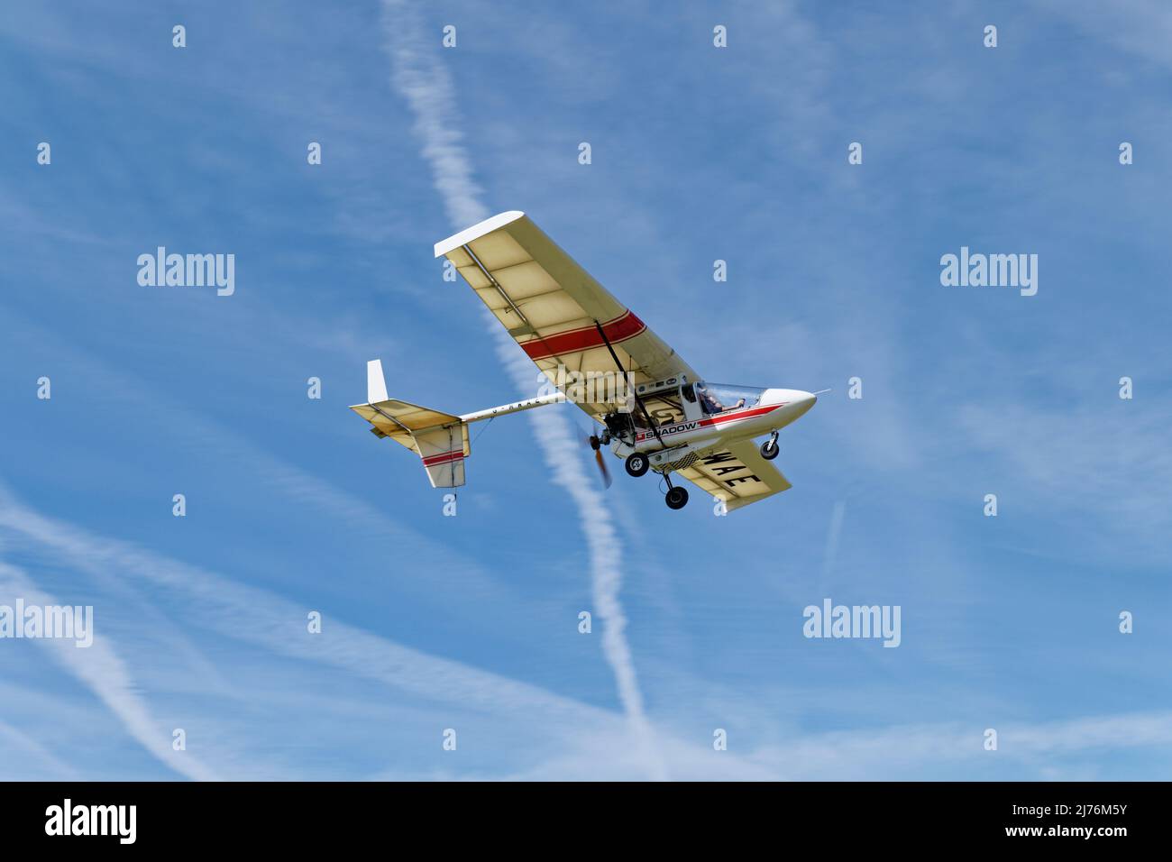 CFM Shadow Microlight aeroplane G-MWAE flies over Popham airfield near Basingstoke in Hampshire for the annual microlight fly in event Stock Photo