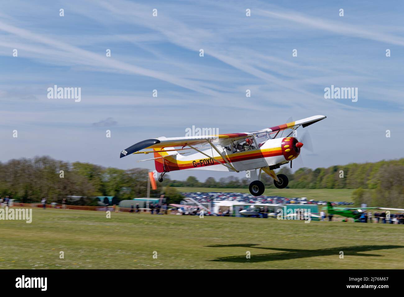 Lovely colourful amateur built Denney Kitfox taildragger aeroplane G-FOXD takes from Popham airfield Hampshire, England during the annual fly-in meet Stock Photo