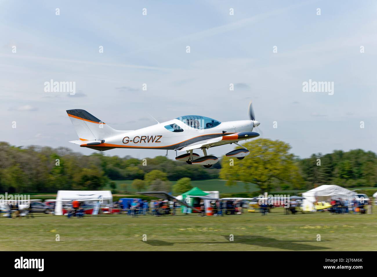 Smart white CZAW Sportscruiser airplane G-CRWZ departs Popham airfield near Basingstoke in Hampshire after attending the annual microlight fly in Stock Photo