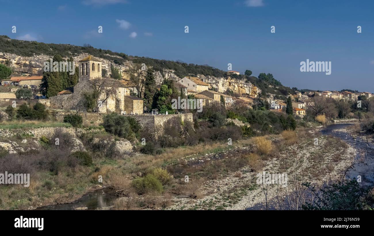 Village view of La Caunette overlooking the river Cesse and the Église Notre Dame whose original Romanesque style building dates back to the XI century. Monument historique. The communal territory belongs to the Regional Natural Park of Haut Languedoc. Stock Photo