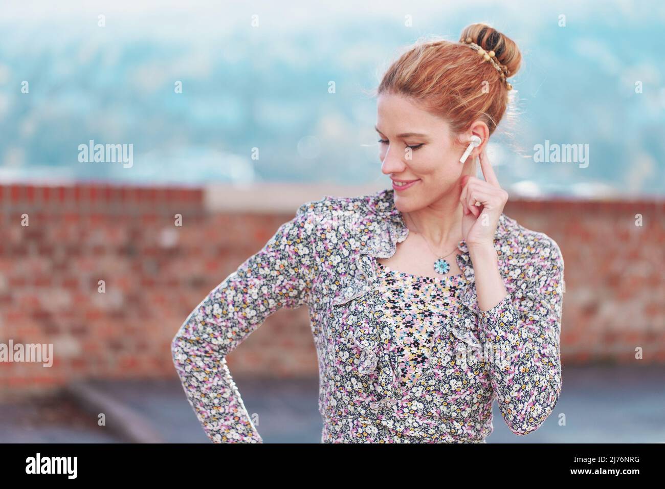 Young redhead white woman listening while calling horizontal Stock Photo