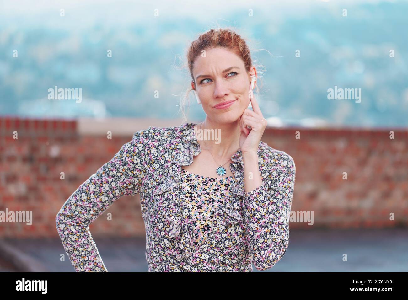 Young redhead sceptic white woman have doubt while calling Stock Photo
