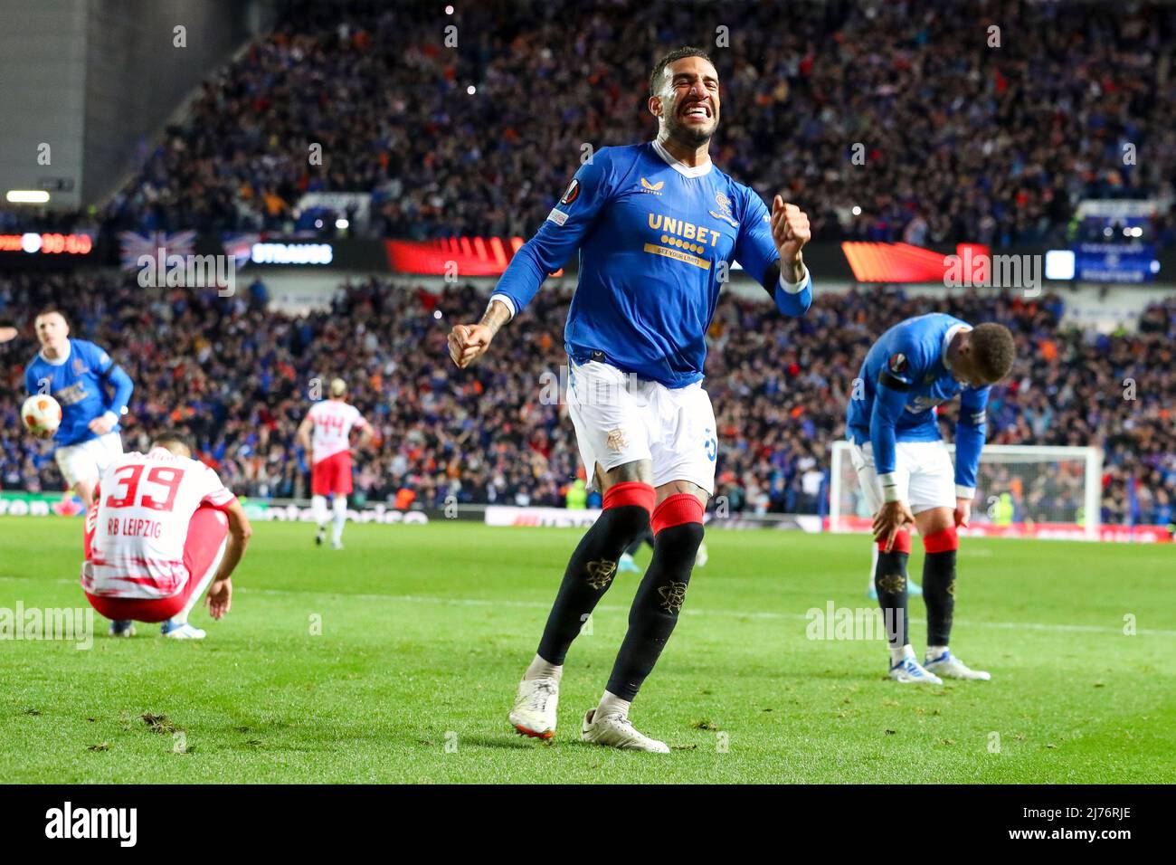 Connor Goldson celebrates Rangers win over RB Leipzig in the semi-finals of the UEFA league, at Ibrox, Glasgow while James Tavernier is behind Stock Photo