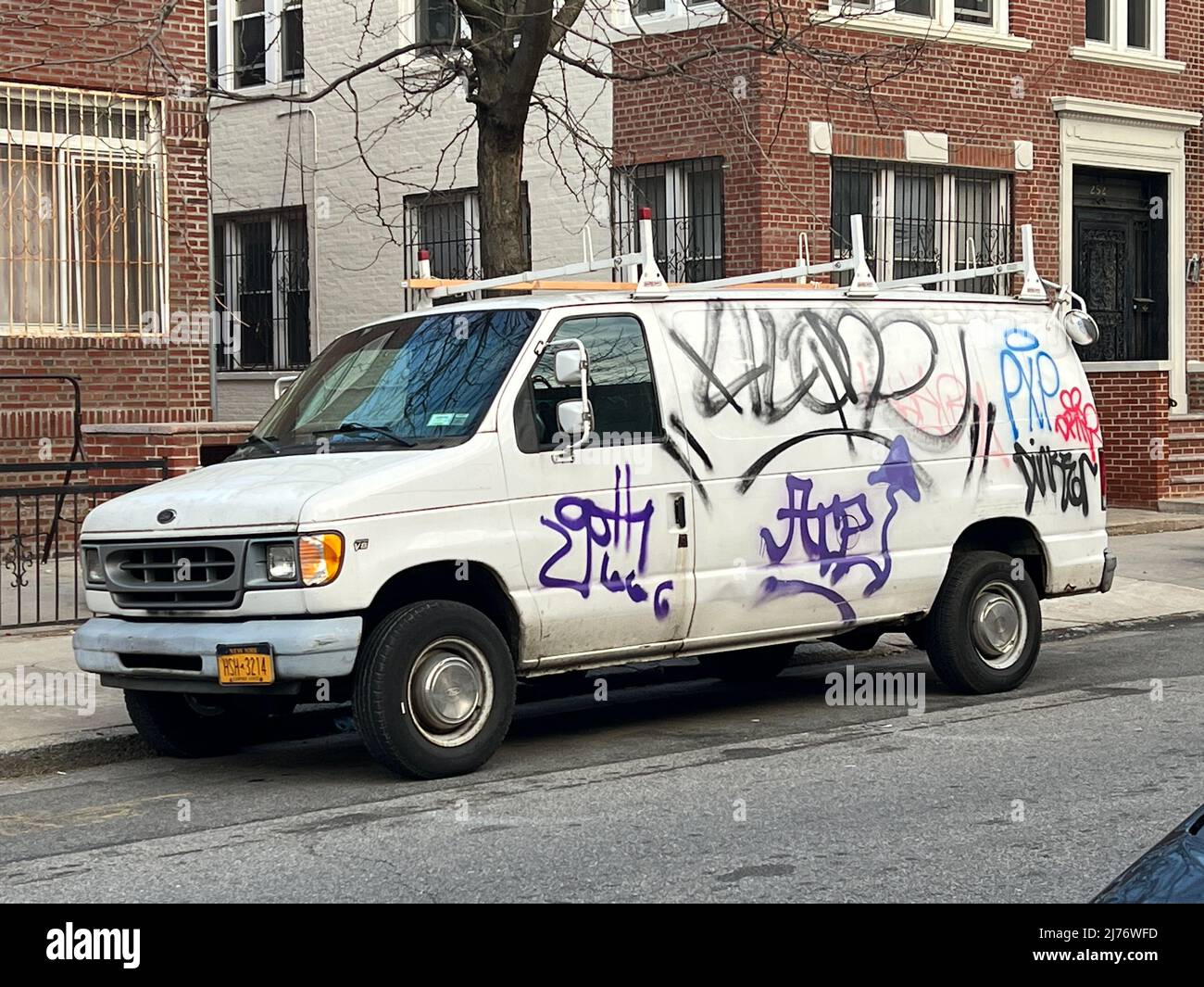 Vans are easy pickings for graffiti type tagging in urban neighborhoods  like this example in Central Brooklyn, New York City Stock Photo - Alamy