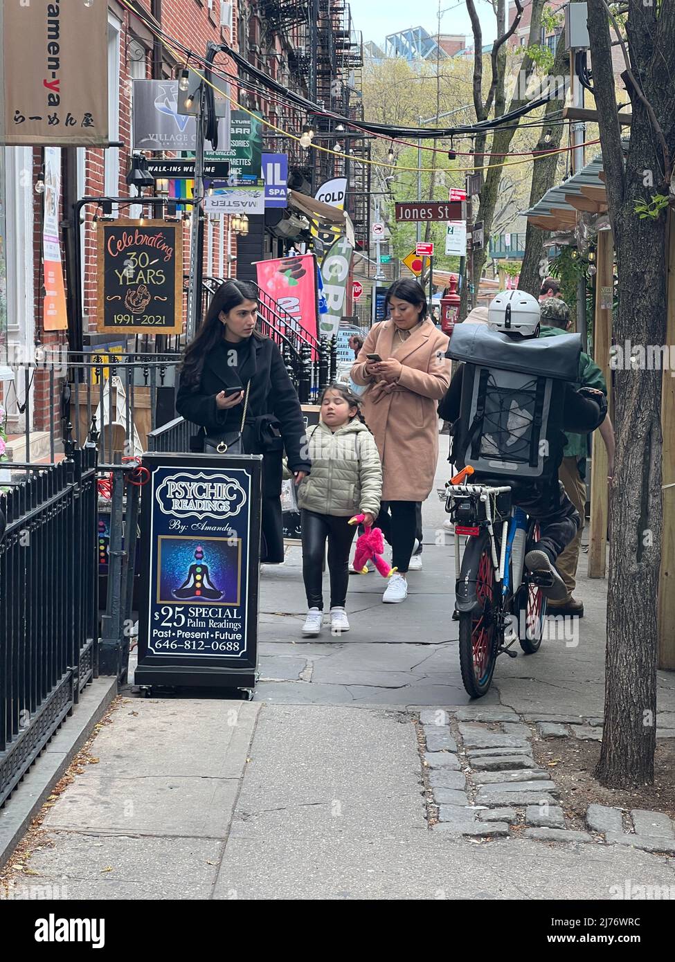 People walk on the quaint West 4th Street west of 6th Avenue in Greenwich Village,  New York City. Stock Photo