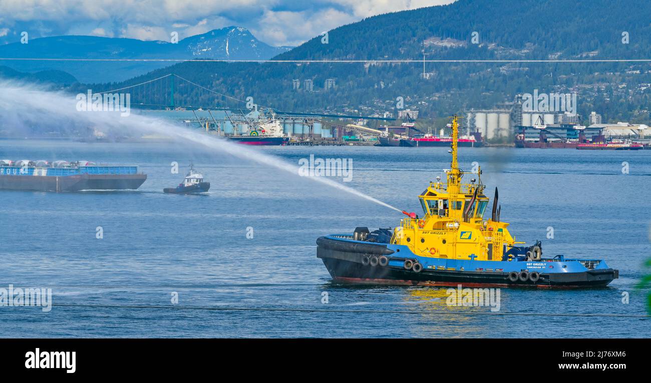SST Grizzzly escort Tug boat employing Fi-Fi 1 standard external fire-fighting system, water cannon,  Vancouver, British Columbia, Canada Stock Photo