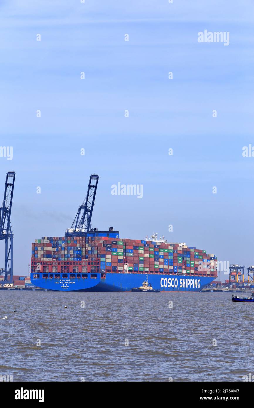 Container ship CSCL Atlantic Ocean entering the Port of Felixstowe, Suffolk, UK assisted by the tug boats Svitzer Deben, Svitzer Sky and Svitzer Kent. Stock Photo