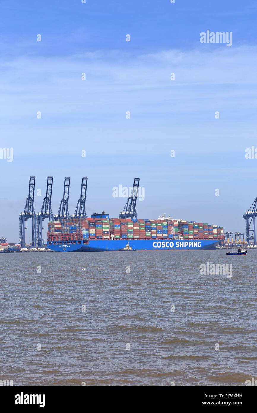 Container ship CSCL Atlantic Ocean entering the Port of Felixstowe, Suffolk, UK assisted by the tug boats Svitzer Deben, Svitzer Sky and Svitzer Kent. Stock Photo
