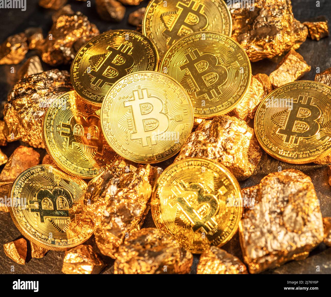 Bitcoins and pieces of gold closeup. Bitcoin against gold, what is the more  attractive asset Stock Photo - Alamy